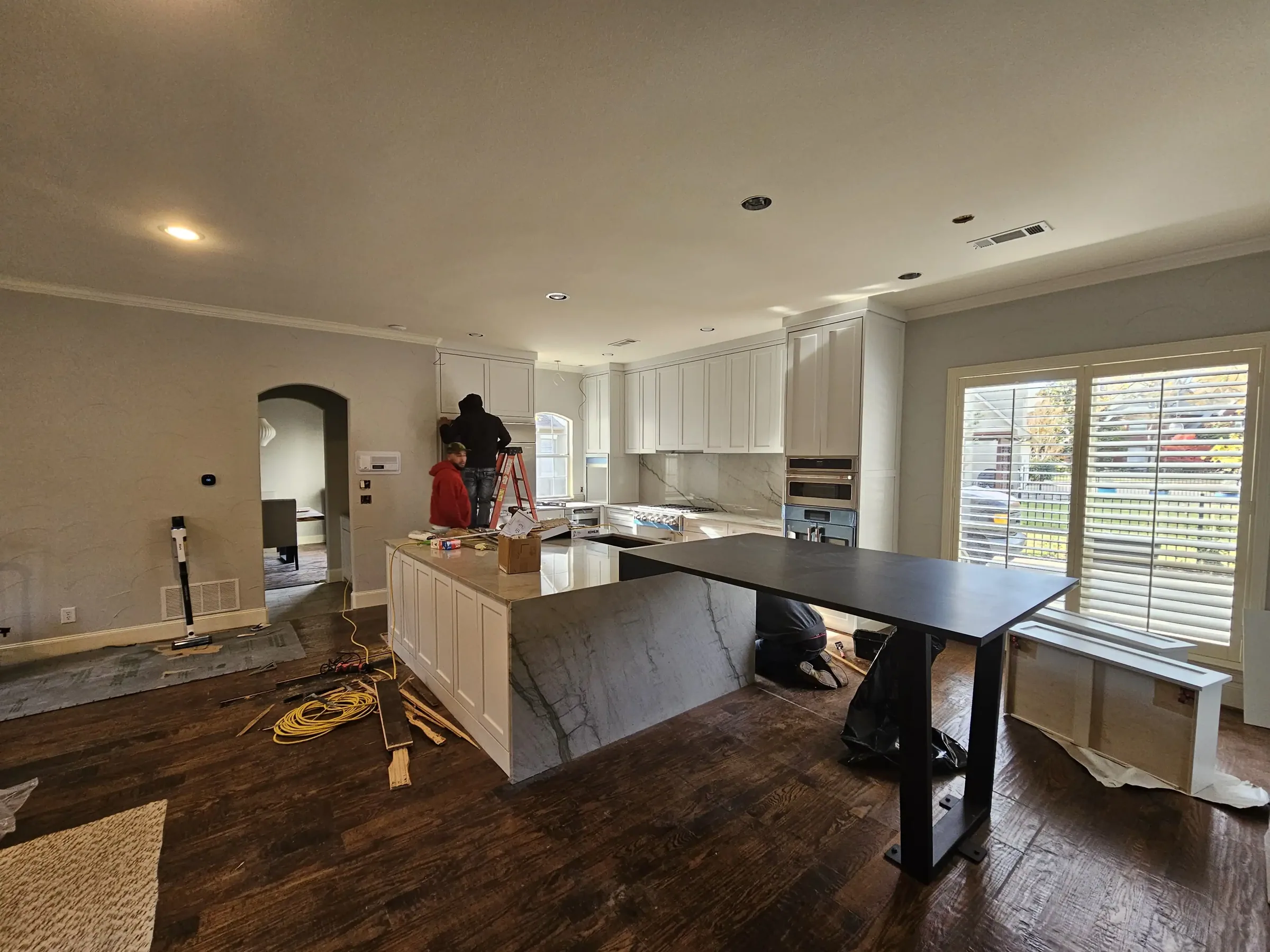 Interior of a custom home looking toward the windows, mid-build on an interior remodel