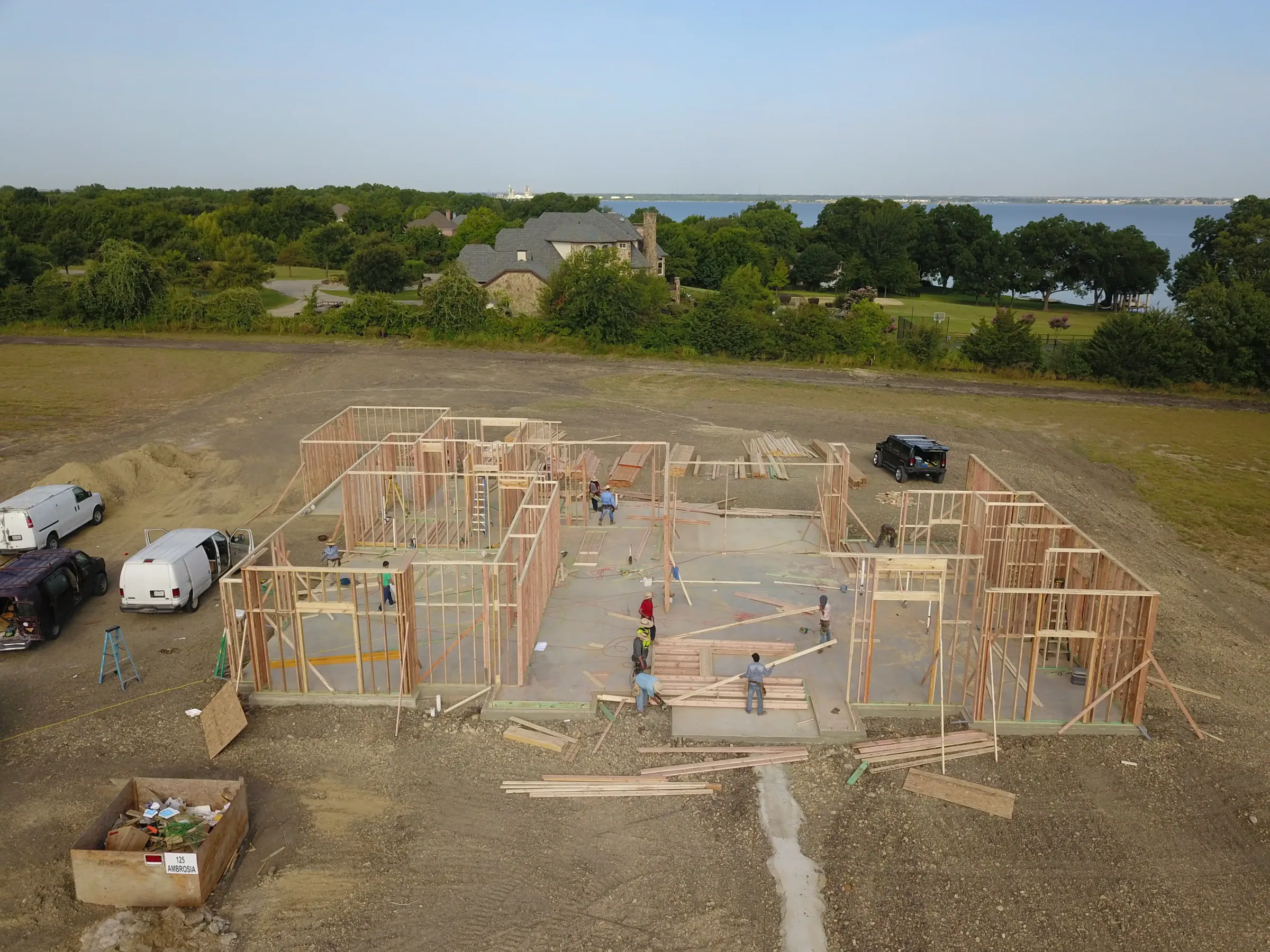 Aerial view of a custom home site from above, in daylight on a job site