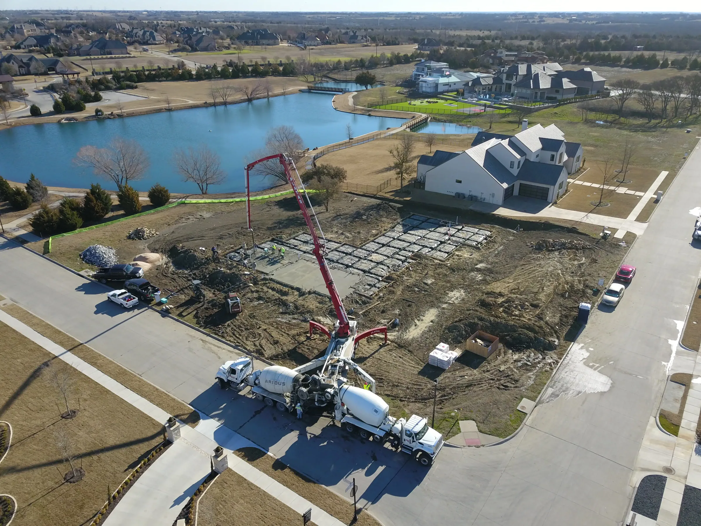 Aerial view of a custom home site from above, with the finishes in on a job site