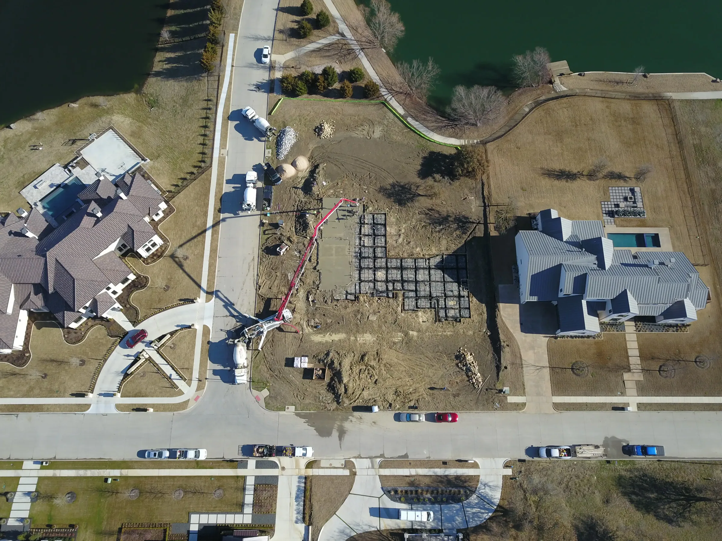 Aerial view of a custom home site from the north side, with the finishes in on a job site