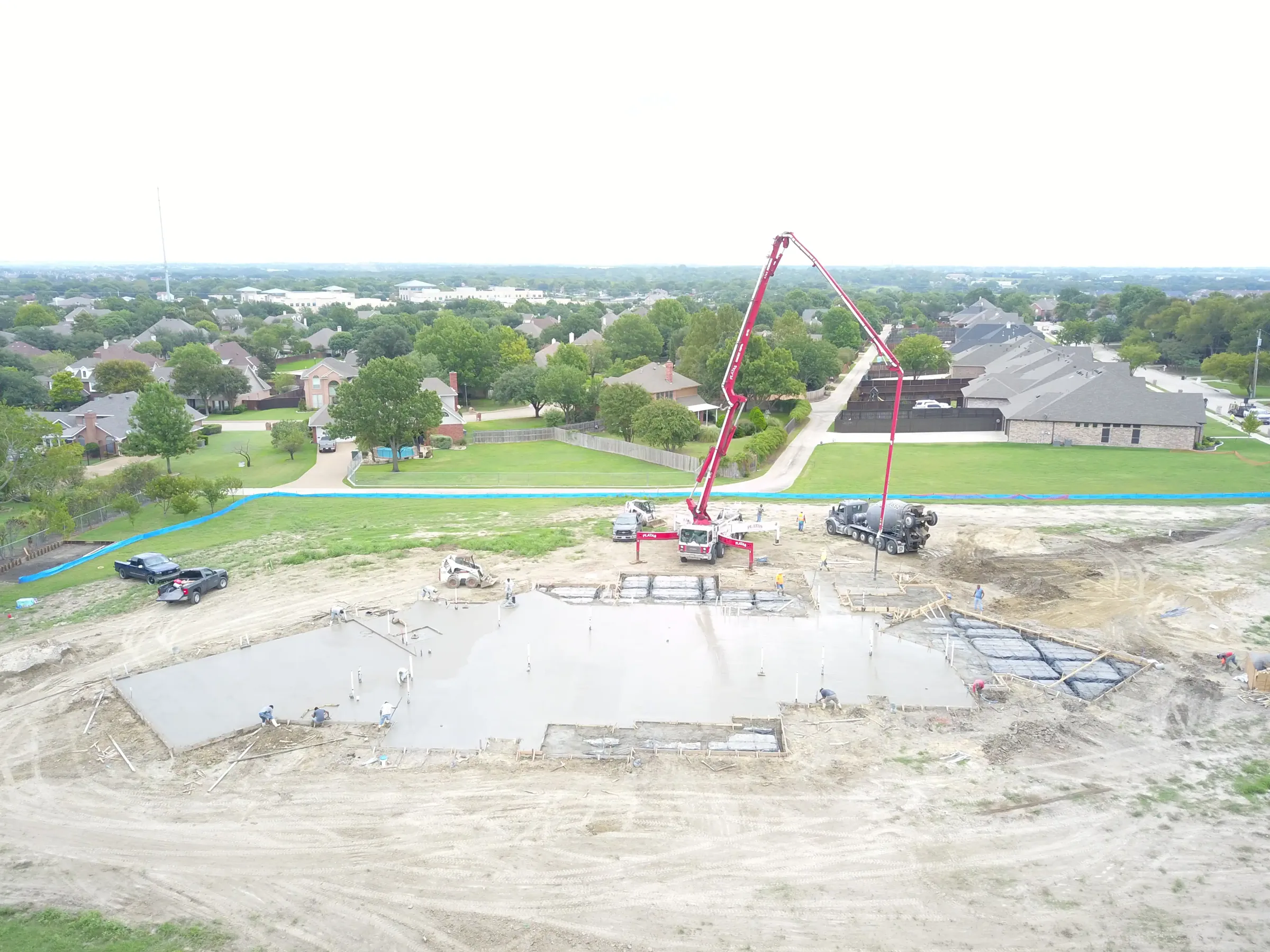Aerial view of a custom home site over the roofline, with the finishes in on a job site