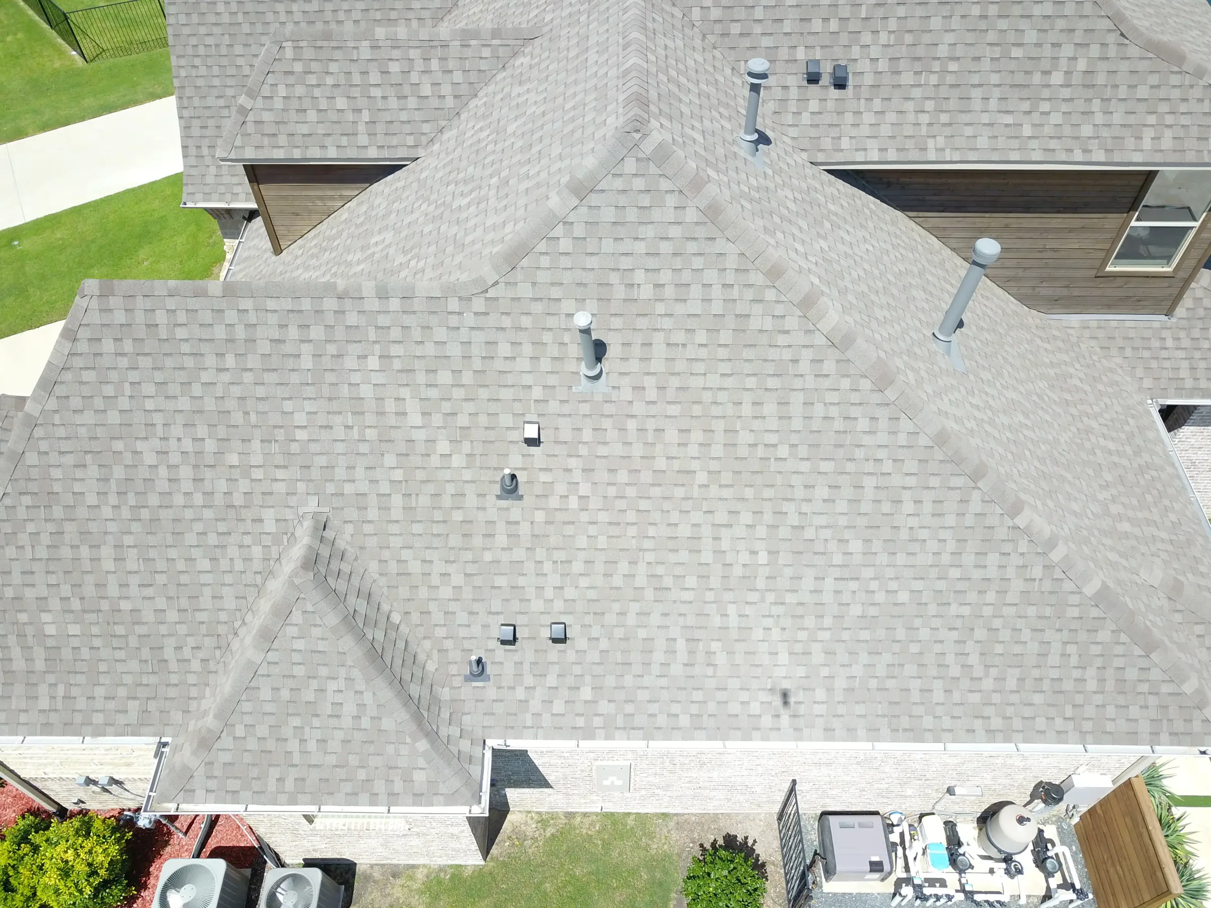 Aerial view of a custom home site from the north side, mid-build on a job site