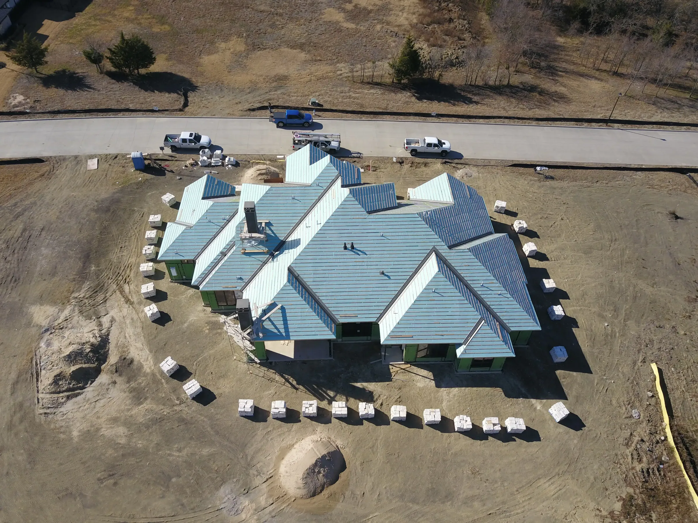 Aerial view of a custom home site from the north side, after completion on a job site