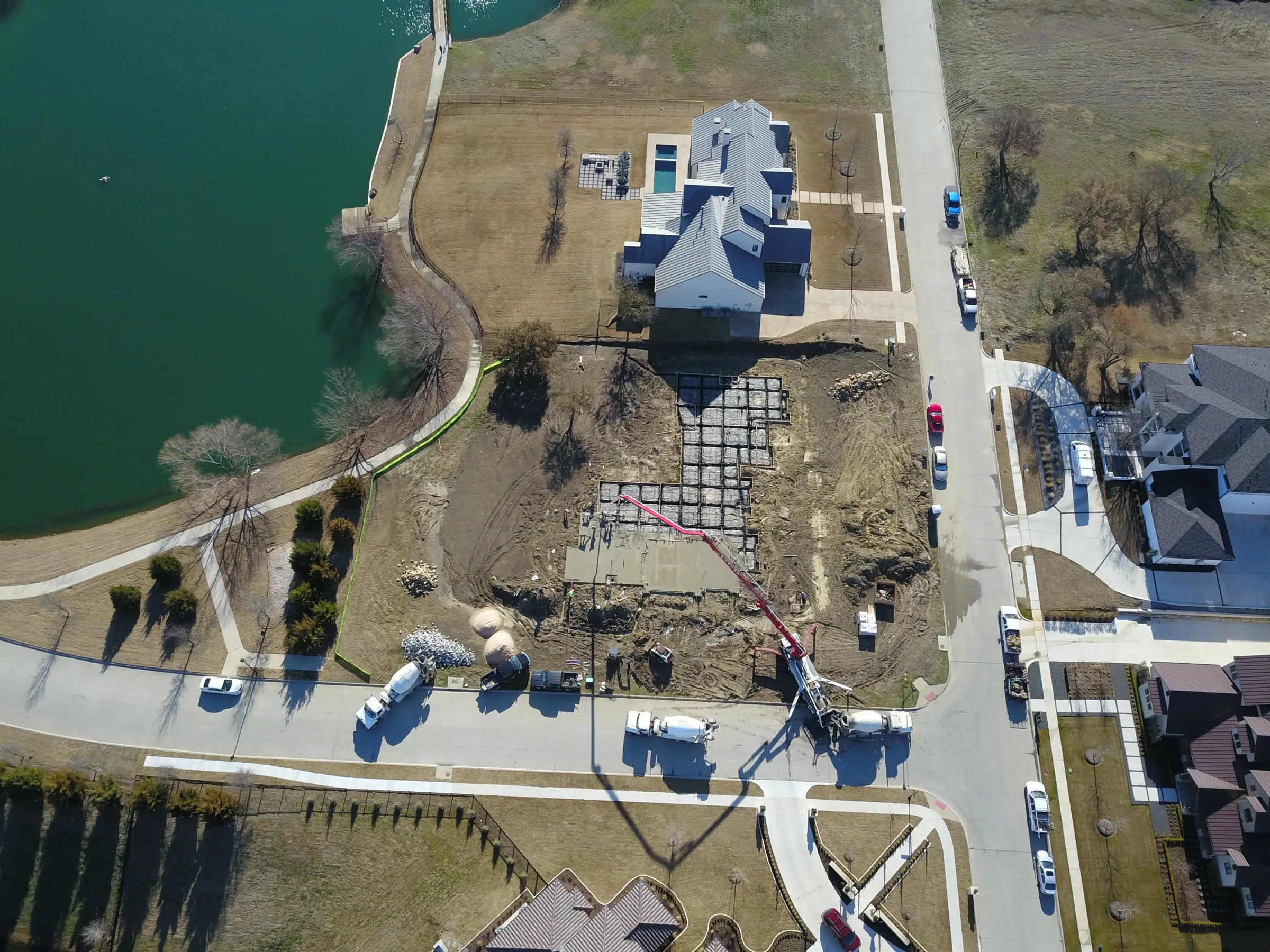 Aerial view of a custom home site across the lot, after completion on a job site