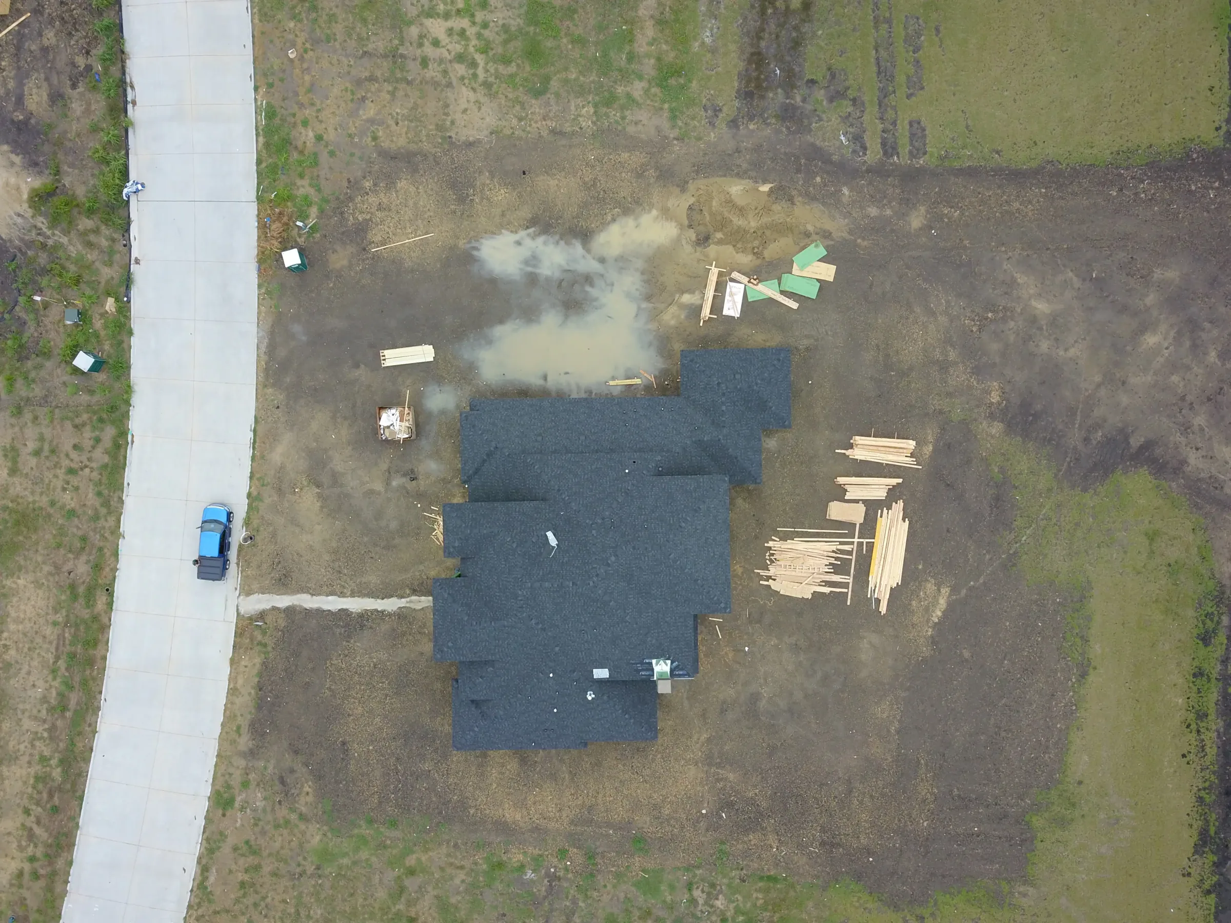 Aerial view of a custom home site from the rear of the property, after completion on a job site
