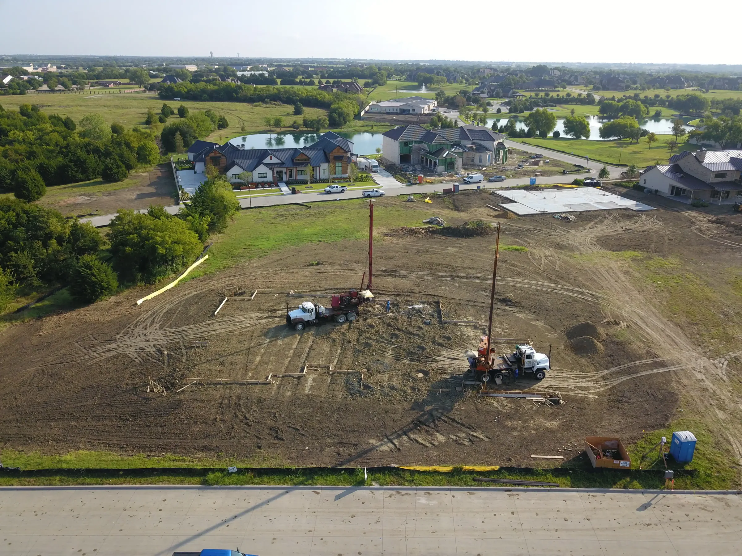 Aerial view of a custom home site from the north side, from a second position on a job site
