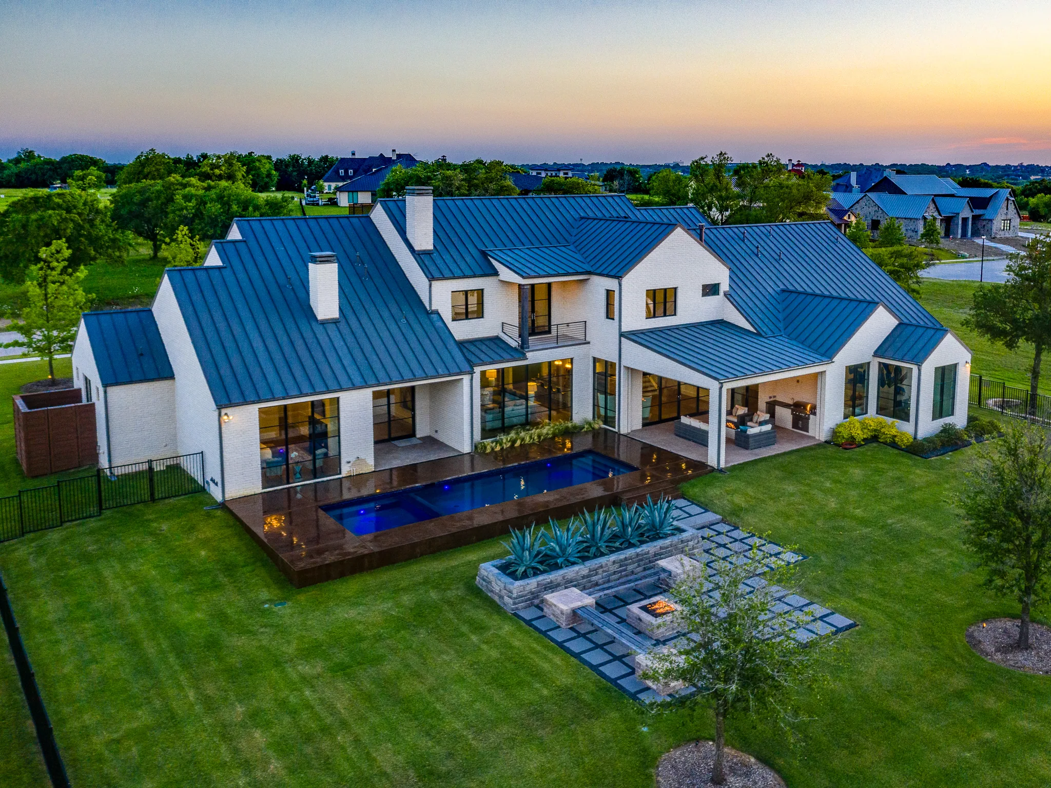 Aerial view of a custom home site looking down the drive, in daylight in Ridge Lakes of Heath