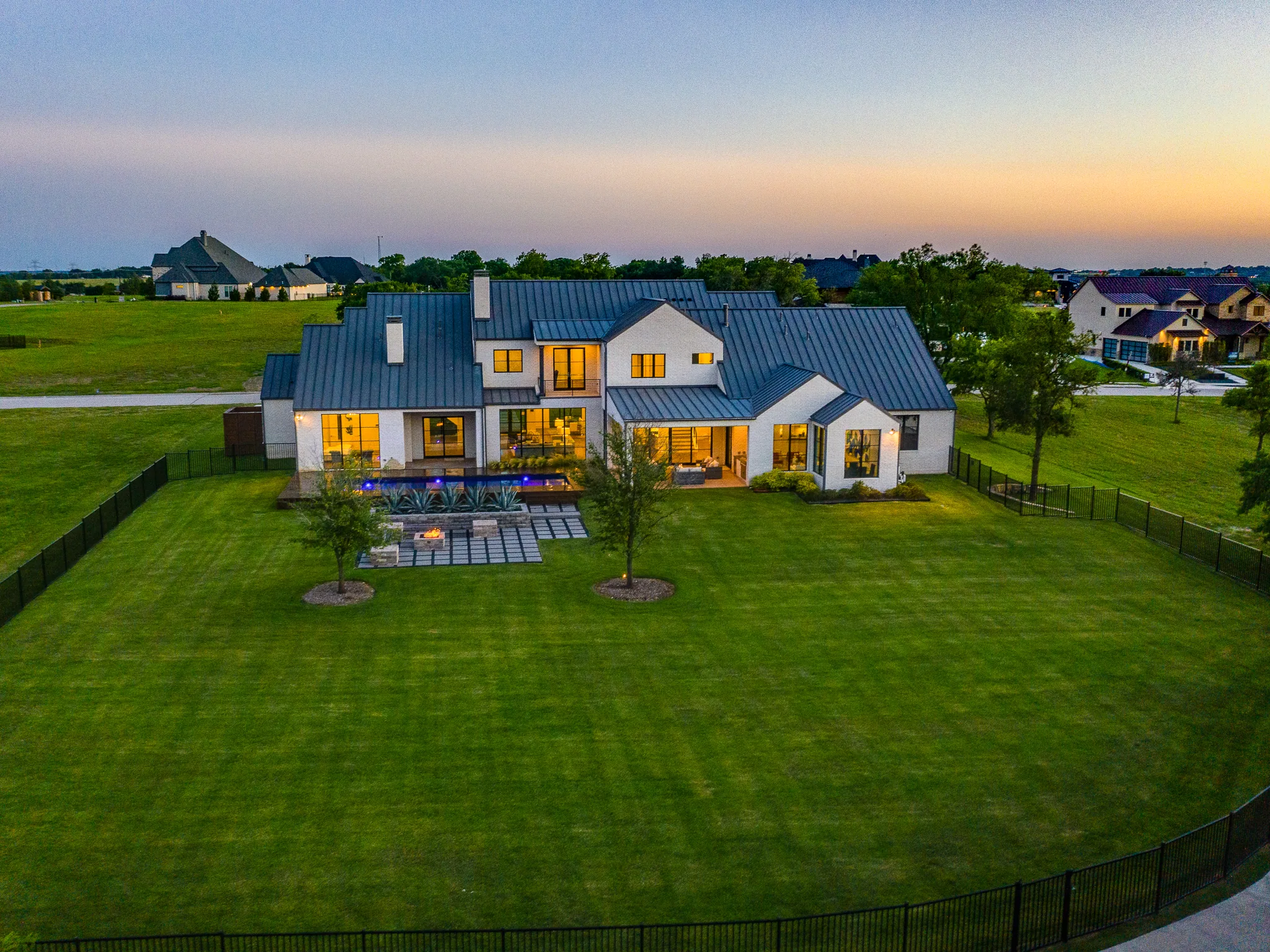 Aerial view of a custom home site looking down the drive, after completion in Ridge Lakes of Heath