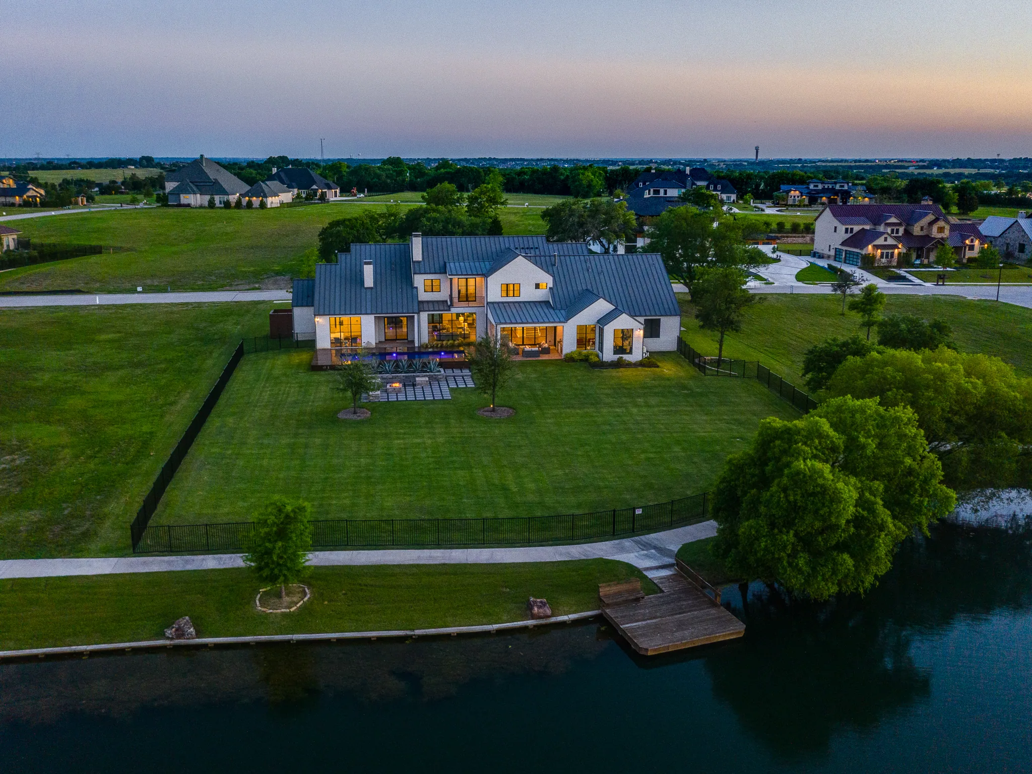 Aerial view of a custom home site over the roofline, after completion in Ridge Lakes of Heath