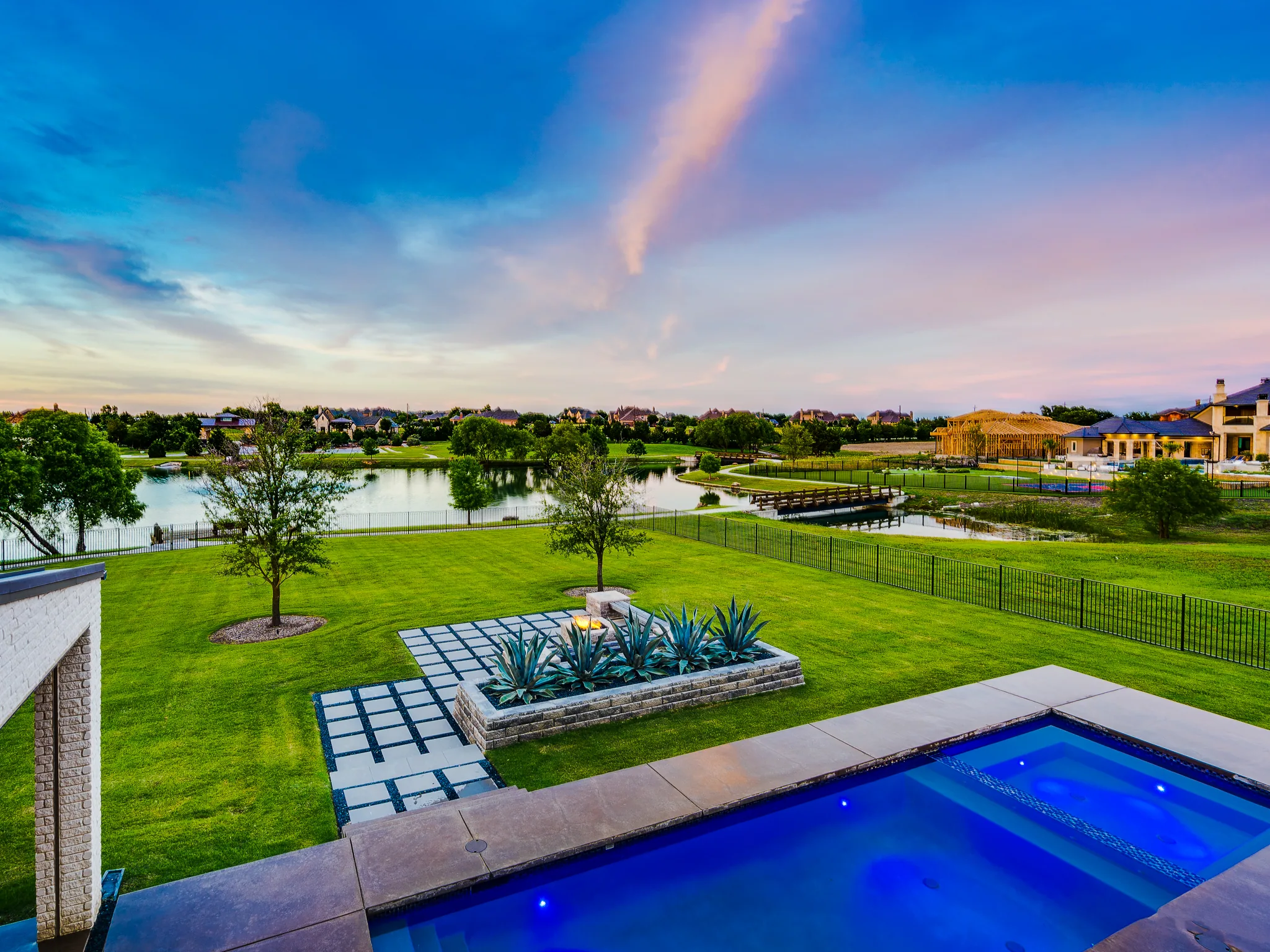 Exterior of a custom home at dusk, with the space empty in Ridge Lakes of Heath