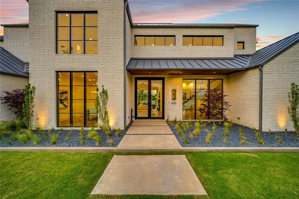 Exterior of a custom home at dusk, before handover in Ridge Lakes of Heath