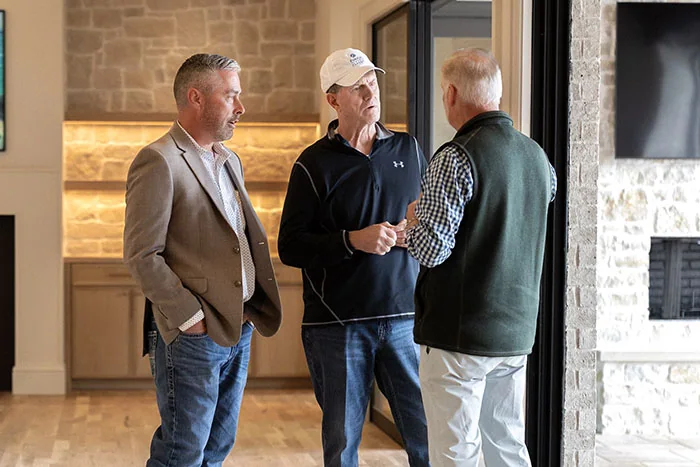 Aaron Jordan Custom Homes with clients at an entry